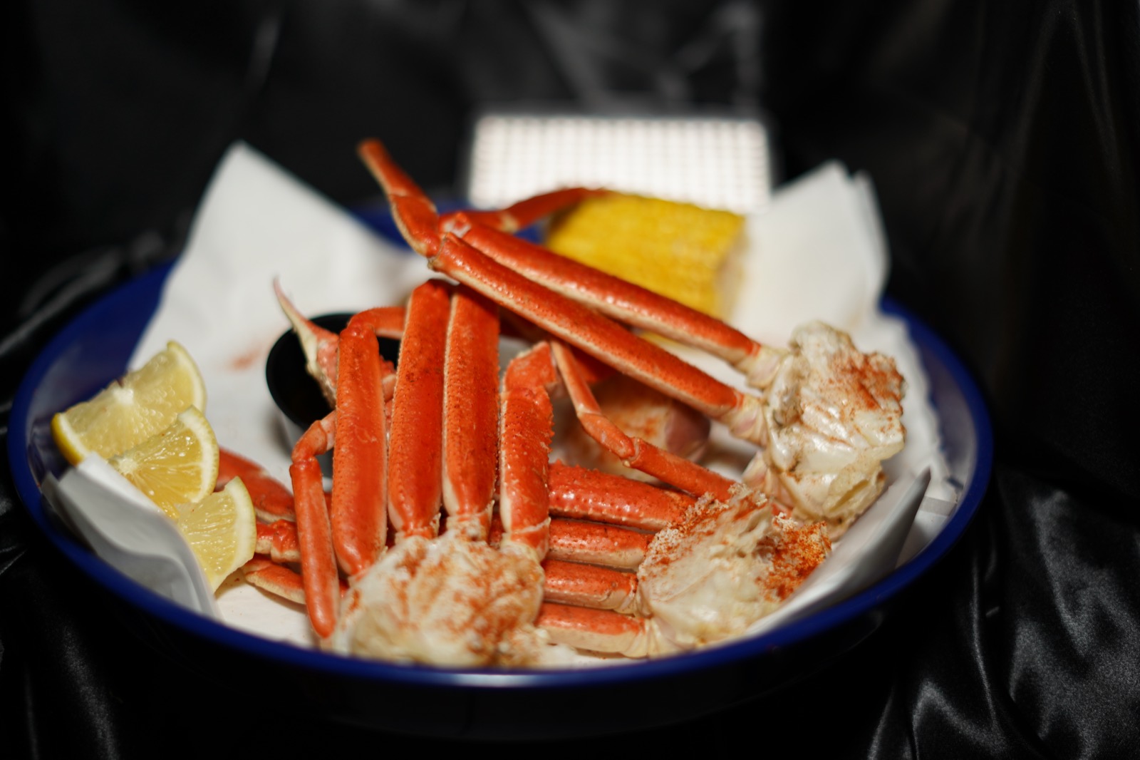 Crab legs with lemon and corn
